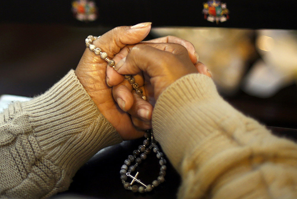 A worshipper prays a rosary at the metropolitan cathedral in Curitiba, Brazil, in this 2014 file photo. (CNS/Amr Abdallah Dalsh, Reuters)