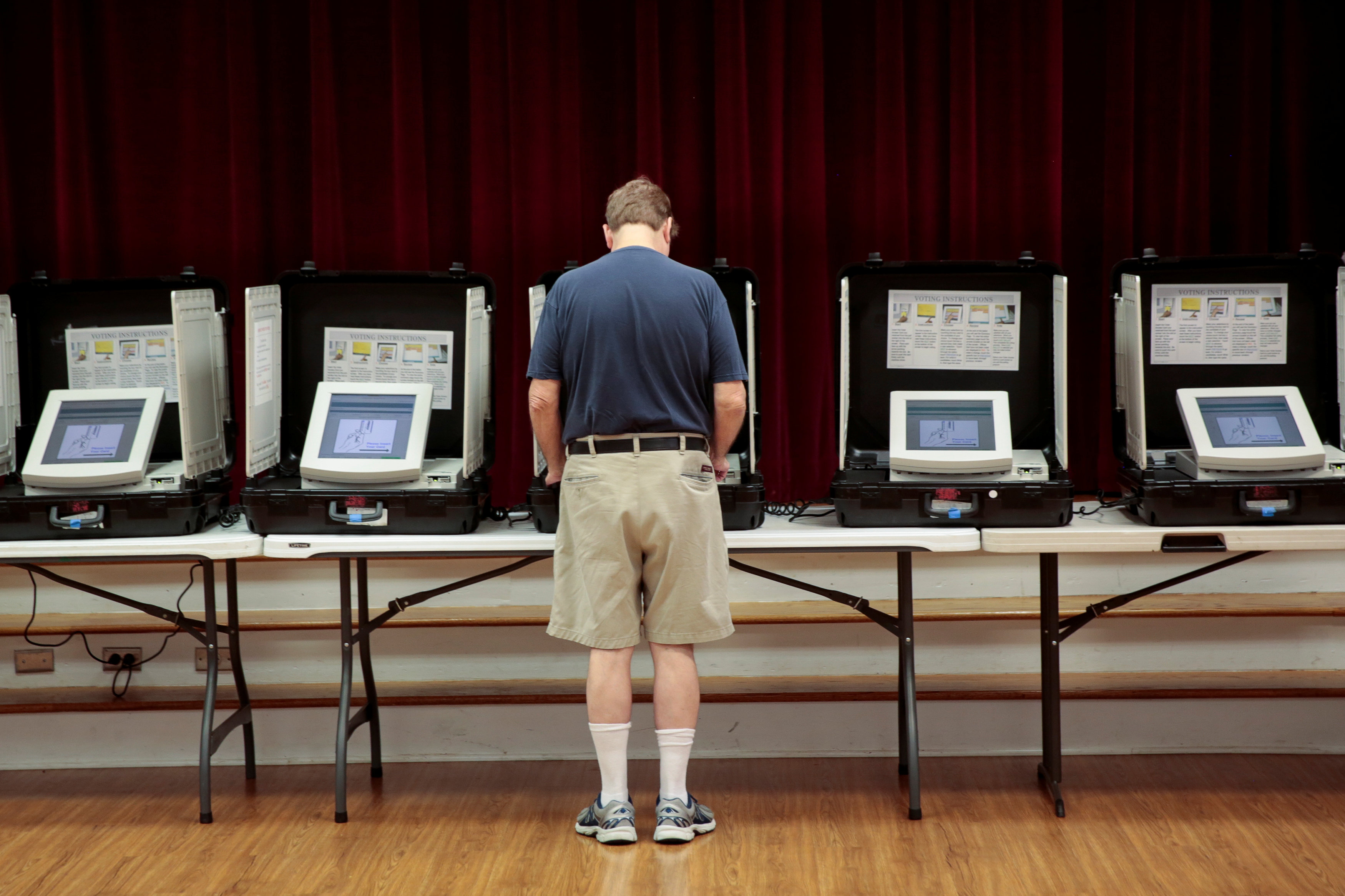 A man casts his vote in 2017 at Holy Cross Catholic Church in Tucker, Ga. (CNS/Chris Aluka Berry, Reuters)