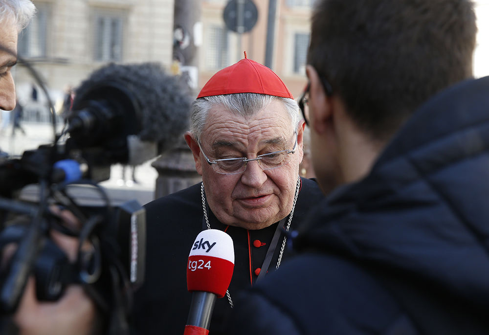 Cardinal Dominik Duka of Prague, Czech Republic, talks with journalists as he leaves the opening session of the meeting on the protection of minors in the church Feb. 21, 2019, at the Vatican. (CNS/Paul Haring) 