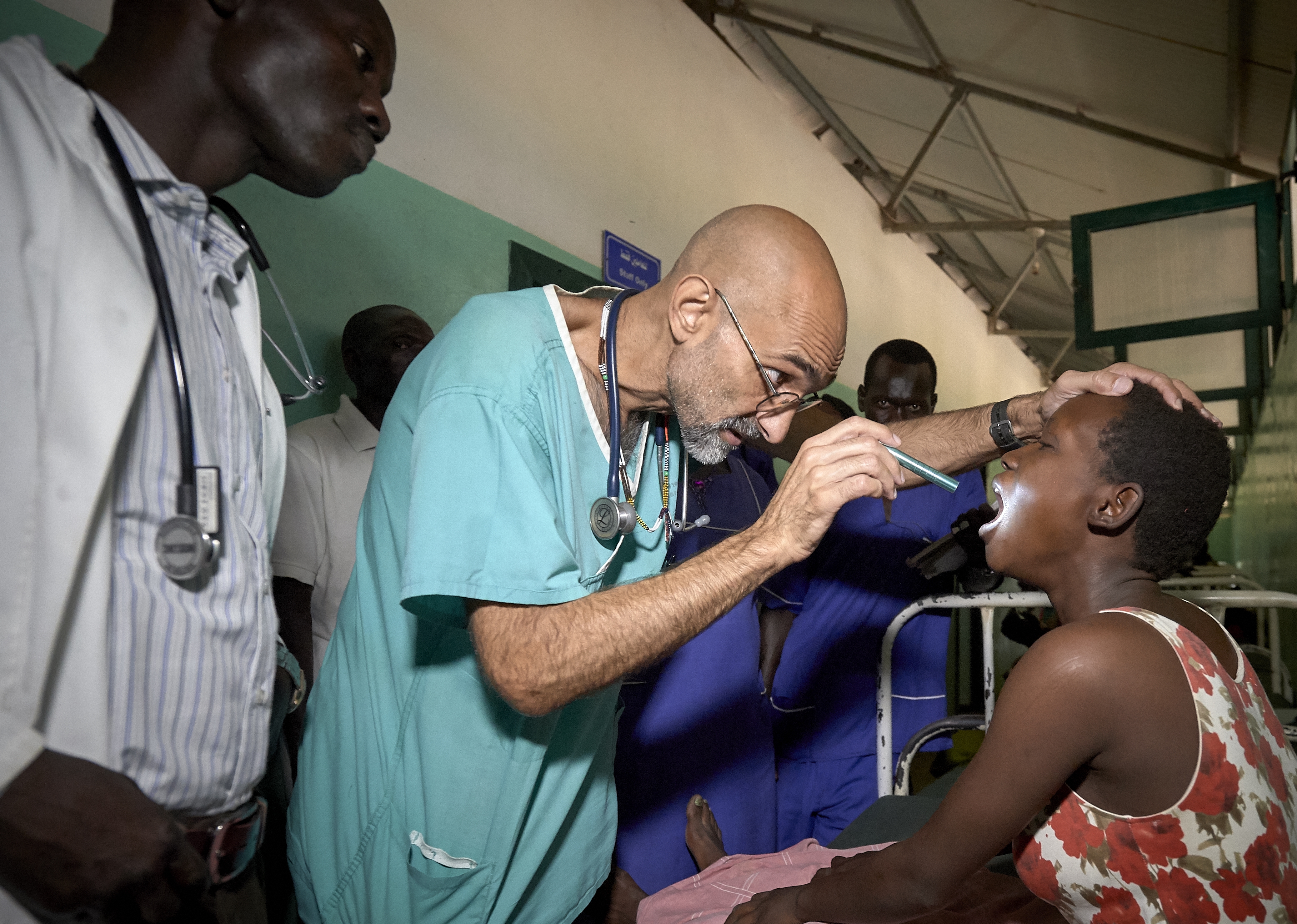 Dr. Tom Catena, a Catholic lay missionary from the United States, examines a patient during rounds in late April at the Mother of Mercy Hospital in Gidel, a village in the Nuba Mountains of Sudan. June 9, 2019 (CNS photo/Paul Jeffrey) 