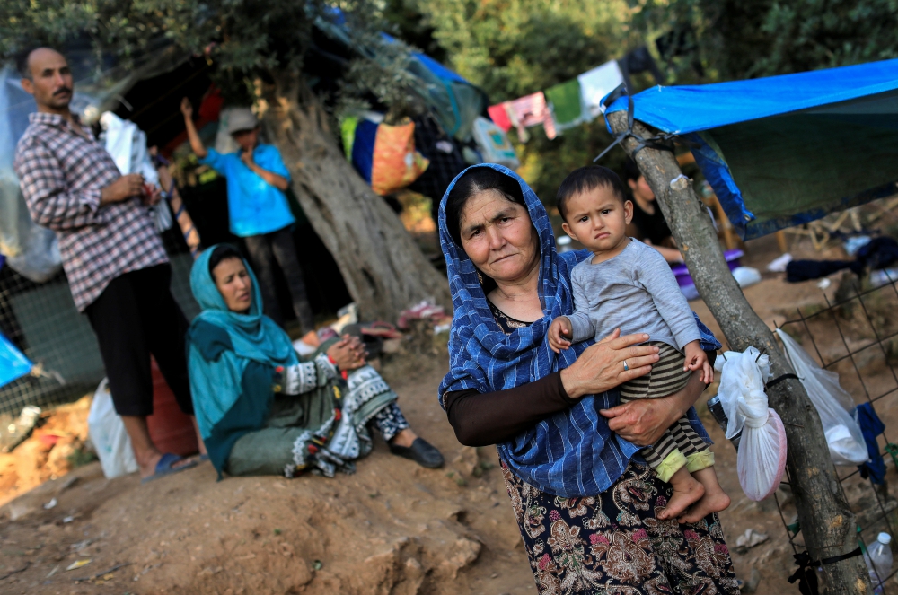 Migrants from Afghanistan are seen at a makeshift camp for refugees and migrants in Samos, Greece, June 25. (CNS/Reuters/Giorgos Moutafis)