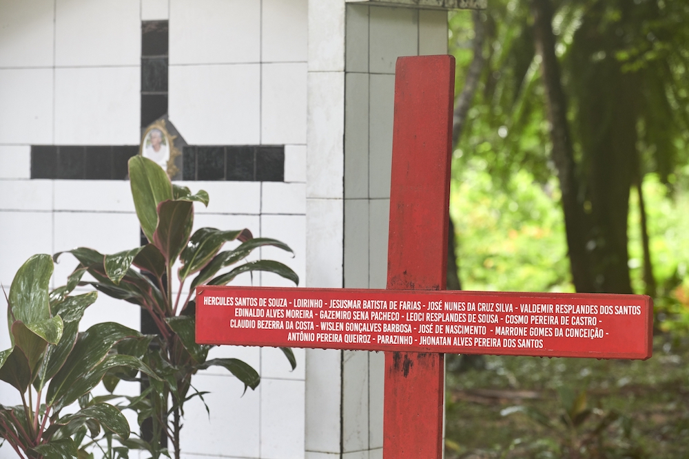 A red cross stands beside the grave of Notre Dame de Namur Sister Dorothy Stang, who was assassinated in the Brazilian Amazon in 2005. The cross bears the names of 16 local rights activists murdered since Stang's killing, and church workers say another cr