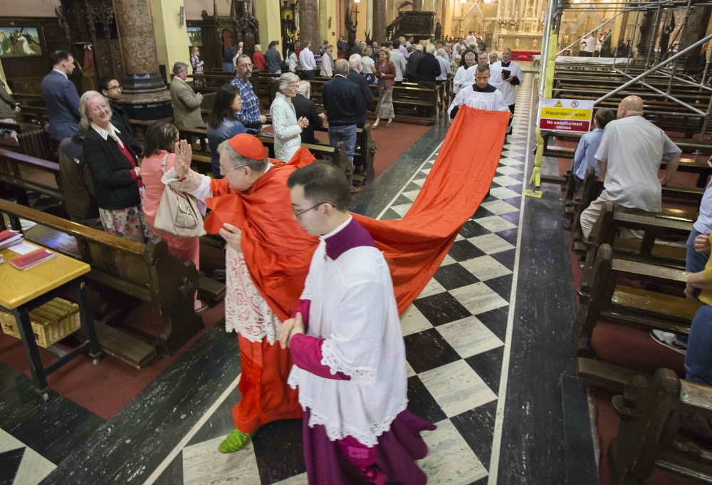 U.S. Cardinal Raymond Burke waves to the congregation after celebrating Mass at Sts. Peter and Paul Church in Cork City, Ireland, July 7. (CNS/Cillian Kelly)