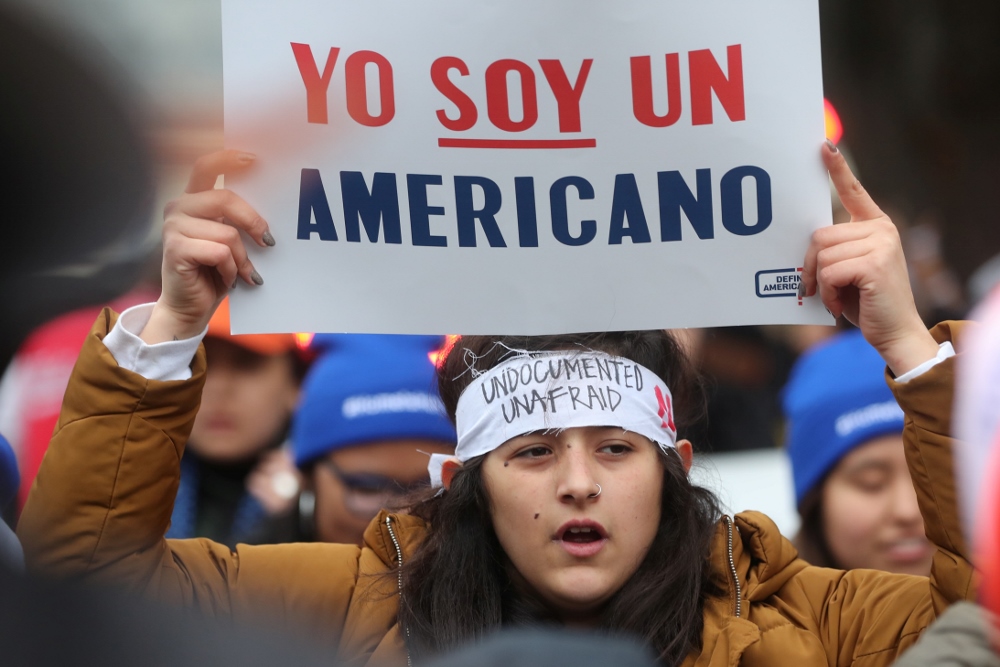 A demonstrator holds a sign outside the U.S. Supreme Court in Washington Nov. 12 as justices hear arguments in a legal challenge to the Trump administration's bid to end the Deferred Action for Childhood Arrivals program. (CNS/Reuters/Jonathan Ernst)