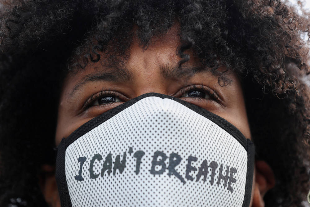 A demonstrator wearing a protective mask takes part in a protest in Rotterdam, Netherlands, June 3, 2020, following the death of George Floyd, an African American man who was taken into custody by Minneapolis police and later died at a Minneapolis hospita