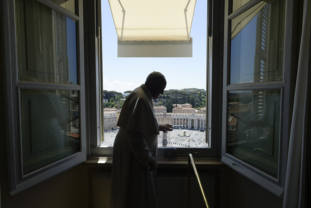 Pope Francis finishes leading the "Regina Coeli" from the window of his studio overlooking St. Peter's Square May 31 at the Vatican. Church officials released the 2019 budget report Oct. 1. (CNS/Vatican Media)