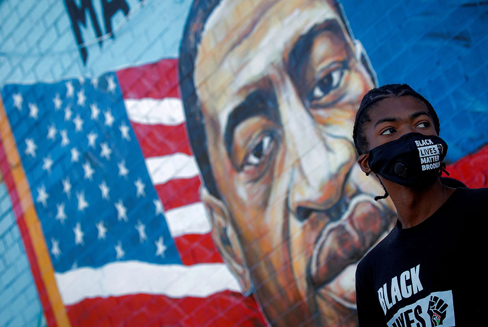 A person in the Brooklyn borough of New York City attends a birthday vigil for George Floyd Oct. 14. Floyd was pinned down May 25 and died at the hands of a Minneapolis police officer. (CNS/Brendan McDermid, Reuters)