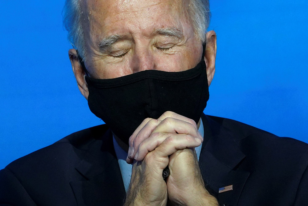 President-elect Joe Biden takes a moment for prayer at his transition headquarters Dec. 8 in Wilmington, Delaware. (CNS/Kevin Lamarque, Reuters)