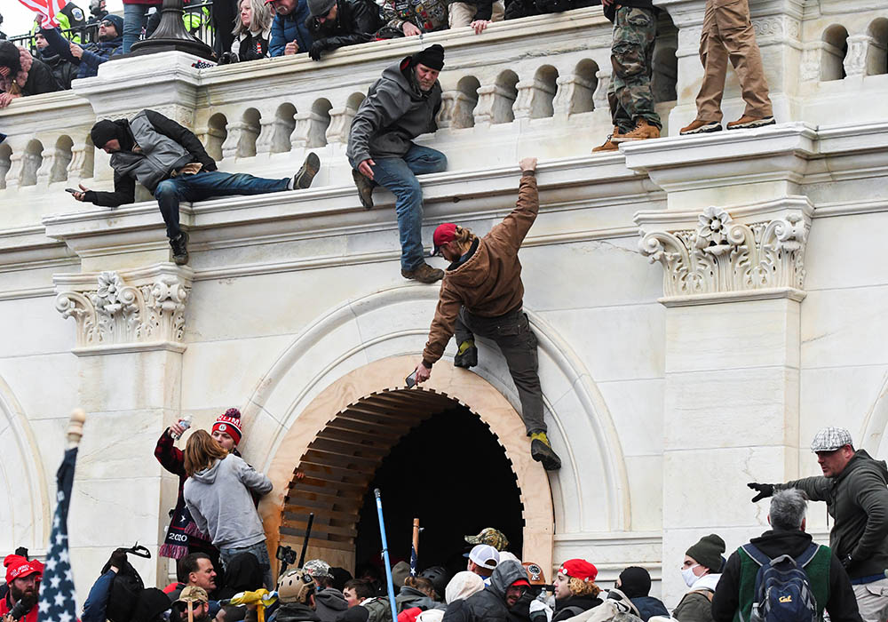 Supporters of President Donald Trump climb on walls at the U.S. Capitol in Washington Jan. 6, 2021, during a protest against Congress certifying the 2020 presidential election. (CNS/Stephanie Keith, Reuters)