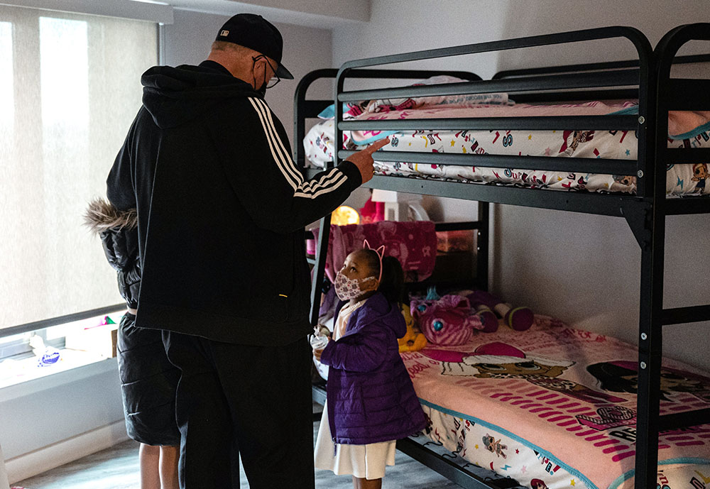 New York Cardinal Timothy Dolan visits Second Farms housing complex in the Bronx borough of New York City on Holy Thursday April 1. The new building opened by Catholic Charities of the Archdiocese of New York has 319 units of affordable housing.