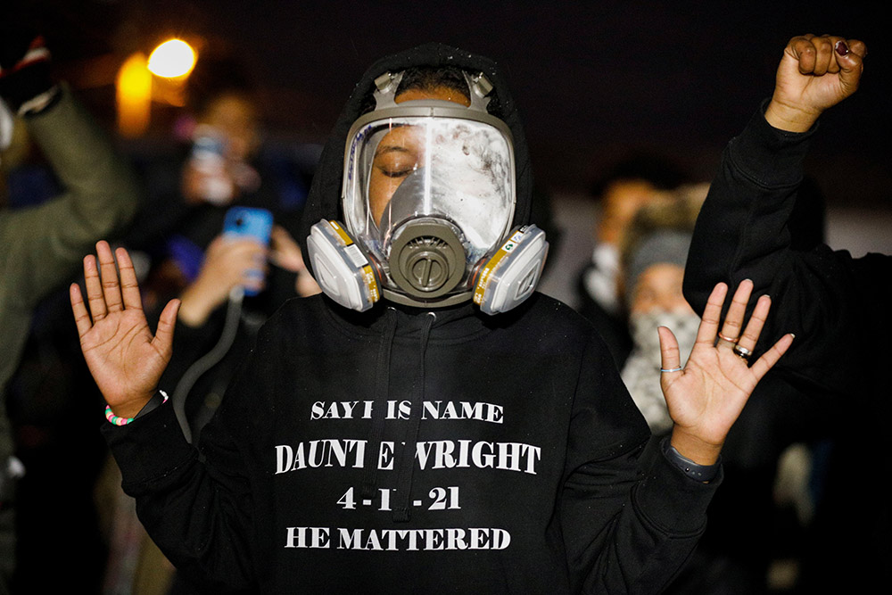 Activists confront state troopers, National Guard members and other law enforcement officers in Brooklyn Center, Minnesota, following an April 13 march in honor of Daunte Wright, 20, who was fatally shot April 11 by a Brooklyn Center police officer. (CNS)