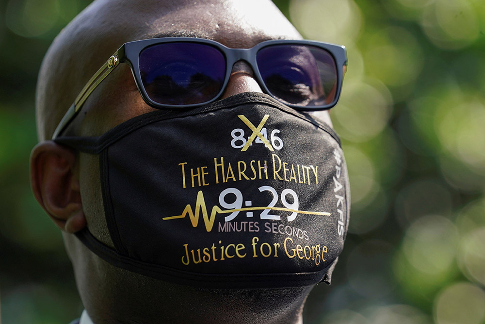 Philonise Floyd wears a face mask referencing his brother George's killing as he and other family members speak with reporters at the White House following their meeting with President Joe Biden in Washington May 25. (CNS/Reuters/Kevin Lamarque)