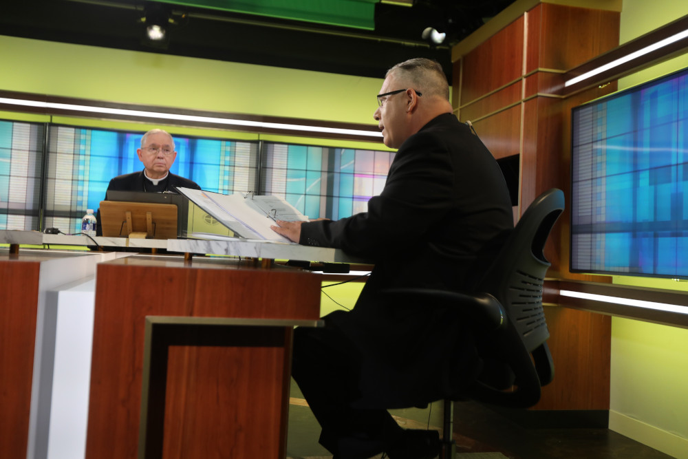 Archbishop José Gomez of Los Angeles, president of the U.S. Conference of Catholic Bishops, looks on as Msgr. Jeffrey Burrill, general secretary, reads a message to Pope Francis June 16 at the U.S. bishops' conference headquarters. (CNS/Bob Roller)