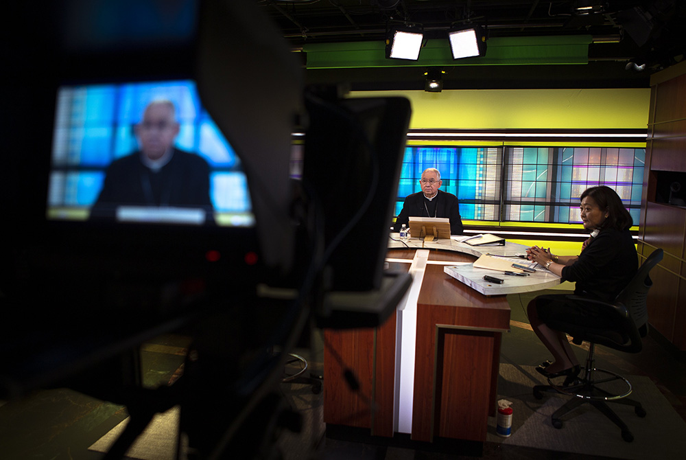 Archbishop José Gomez of Los Angeles, president of the U.S. Conference of Catholic Bishops, and Chieko Noguchi, the bishops' conference director of public affairs, hold a news conference at the bishops' conference headquarters in Washington June 16, the f