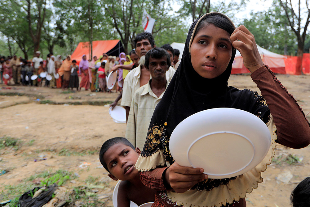 Rohingya refugees line up to get food from the Turkish Cooperation and Coordination Agency near Cox's Bazar Oct. 21, 2017, in Bangladesh. (CNS/Reuters/Zohra Bensemra)