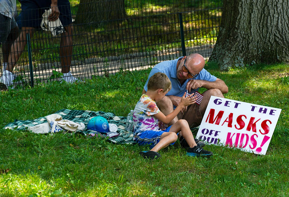 A child and an adult are seen during a demonstration against COVID-19 vaccines and restrictions July 24, 2021, in New York City. (CNS/Reuters/David Delgado)