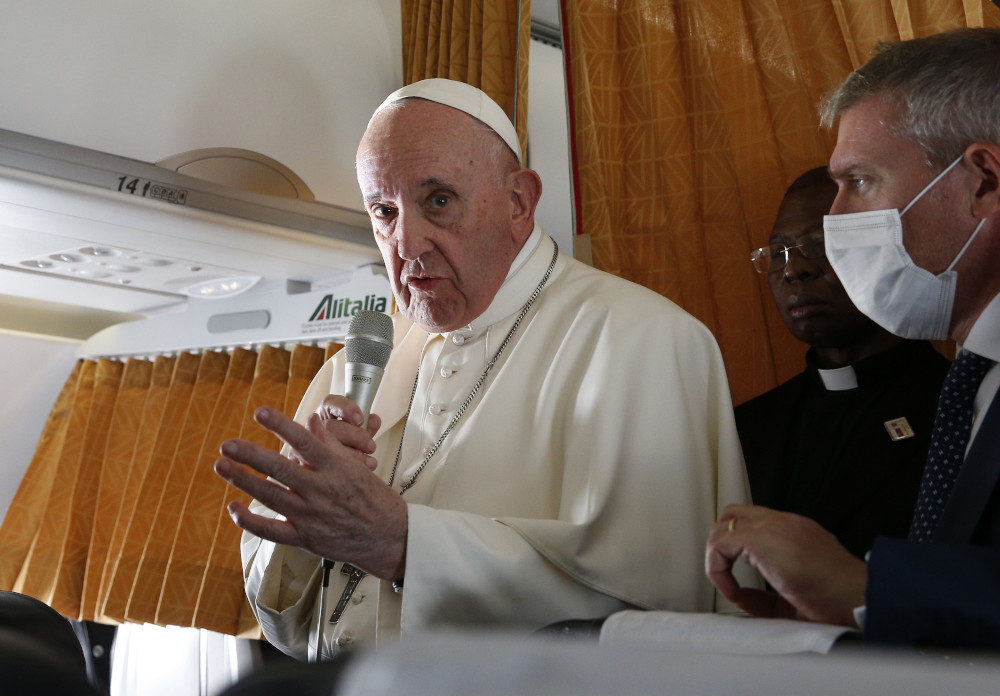 Pope Francis answers questions from journalists aboard his flight from Bratislava, Slovakia, to Rome Sept. 15. (CNS/Paul Haring)