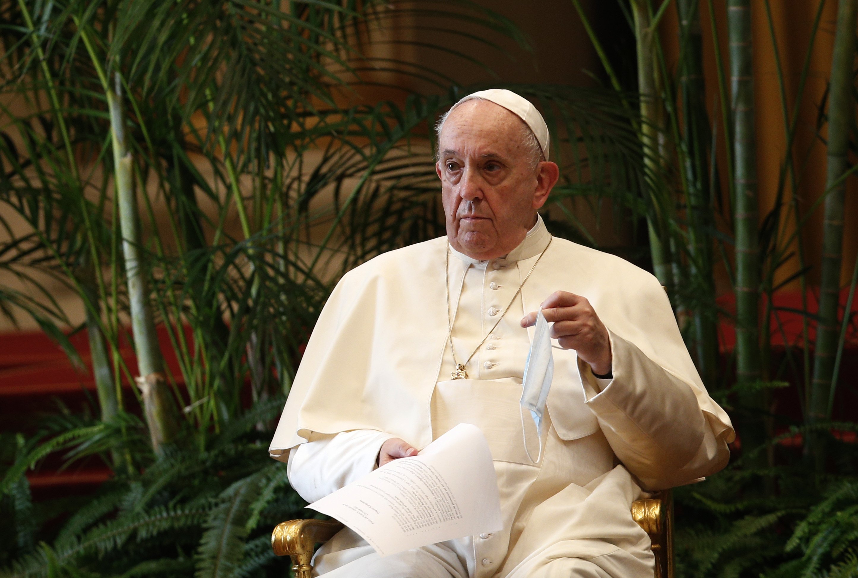 Pope Francis holds a text and his mask during the meeting, “Faith and Science: Towards COP26,” with religious leaders in the Apostolic Palace at the Vatican Oct. 4, 2021. The meeting was part of the run-up to the U.N. Climate Change Conference, called COP