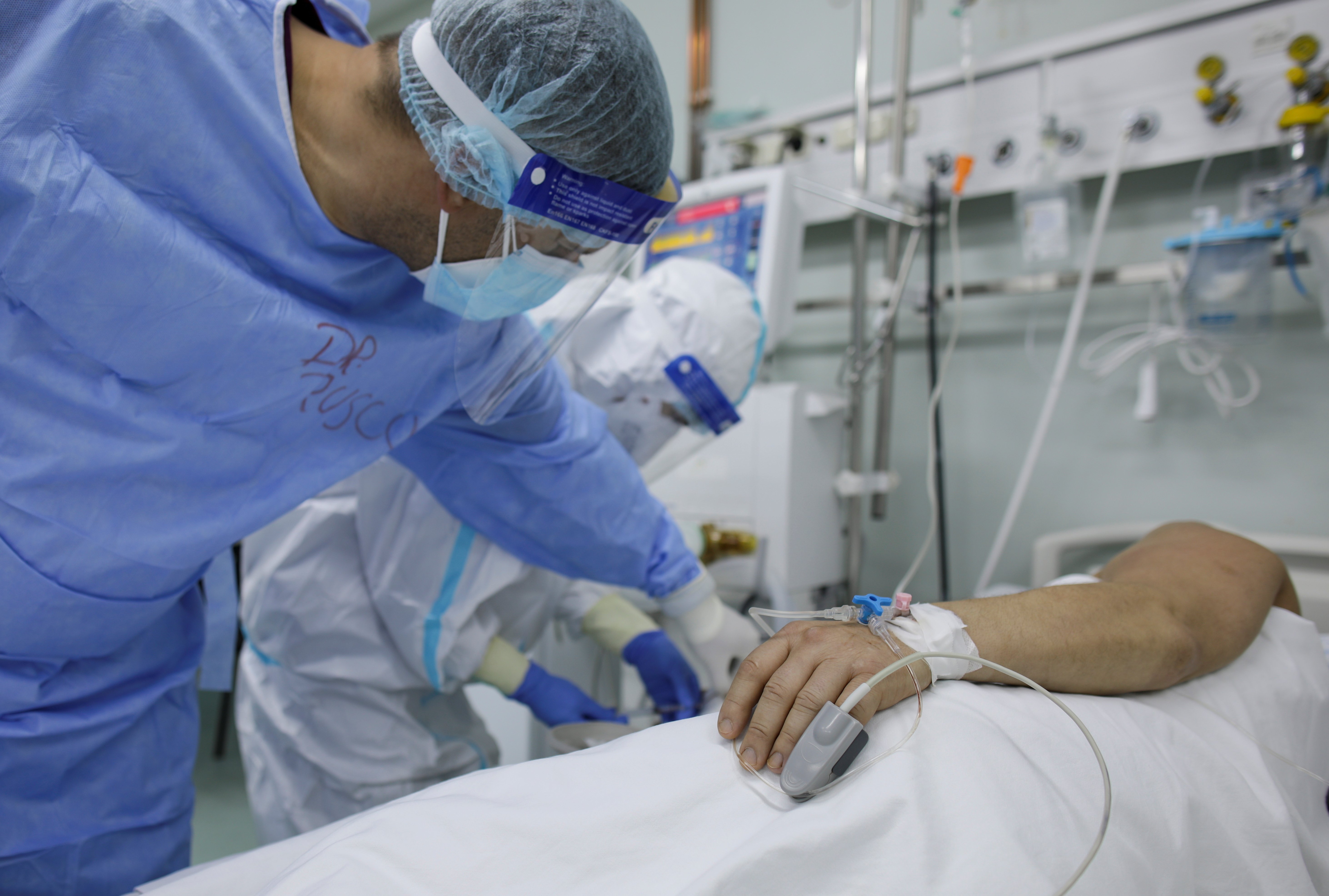 A doctor and nurse at Marius Nasta Pneumology Institute in Bucharest, Romania, take care of a coronavirus patient Oct. 17, 2021. (CNS photo/Inquam Photos, Octav Ganea via Reuters)