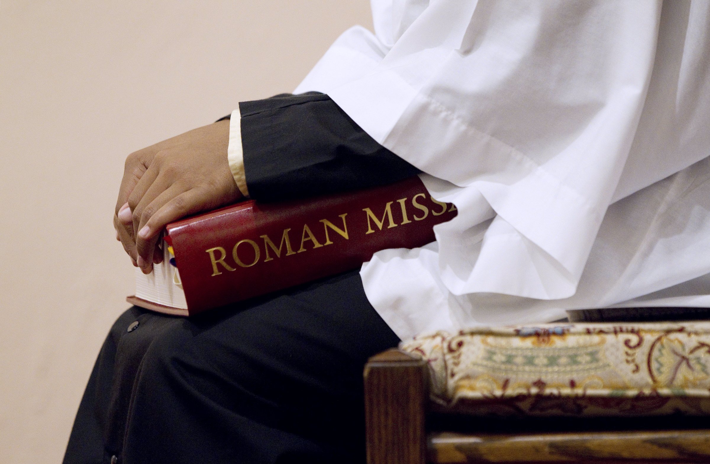 An altar server holds a copy of the Roman Missal during Mass at St. Joseph Catholic Church in Alexandria, Va., in this 2011 file photo. (CNS photo/Nancy Phelan Wiechec)