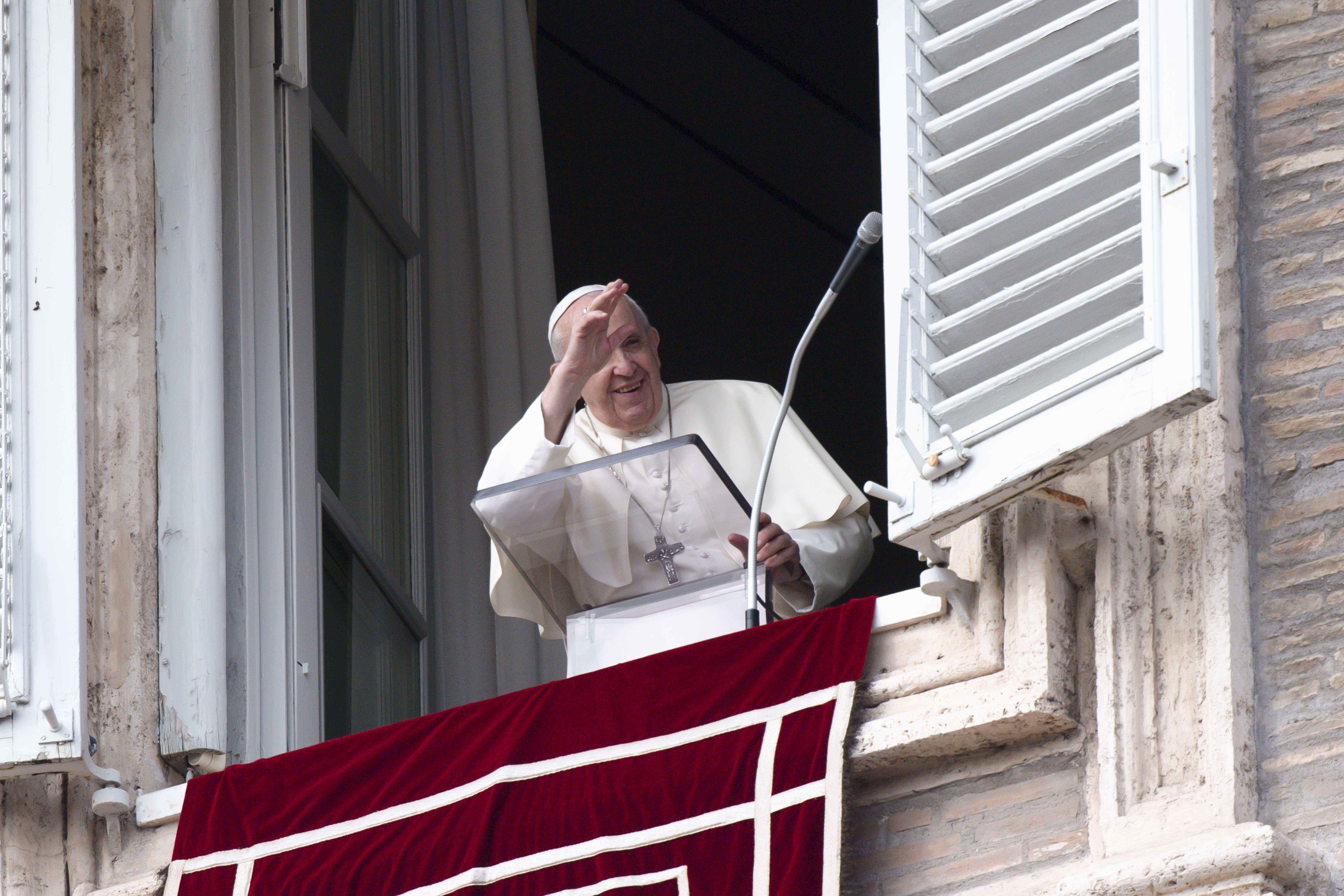 Pope Francis greets people as he leads the Angelus from the window of his studio overlooking St. Peter's Square at the Vatican Oct. 31, 2021. (CNS photo/Vatican Media)