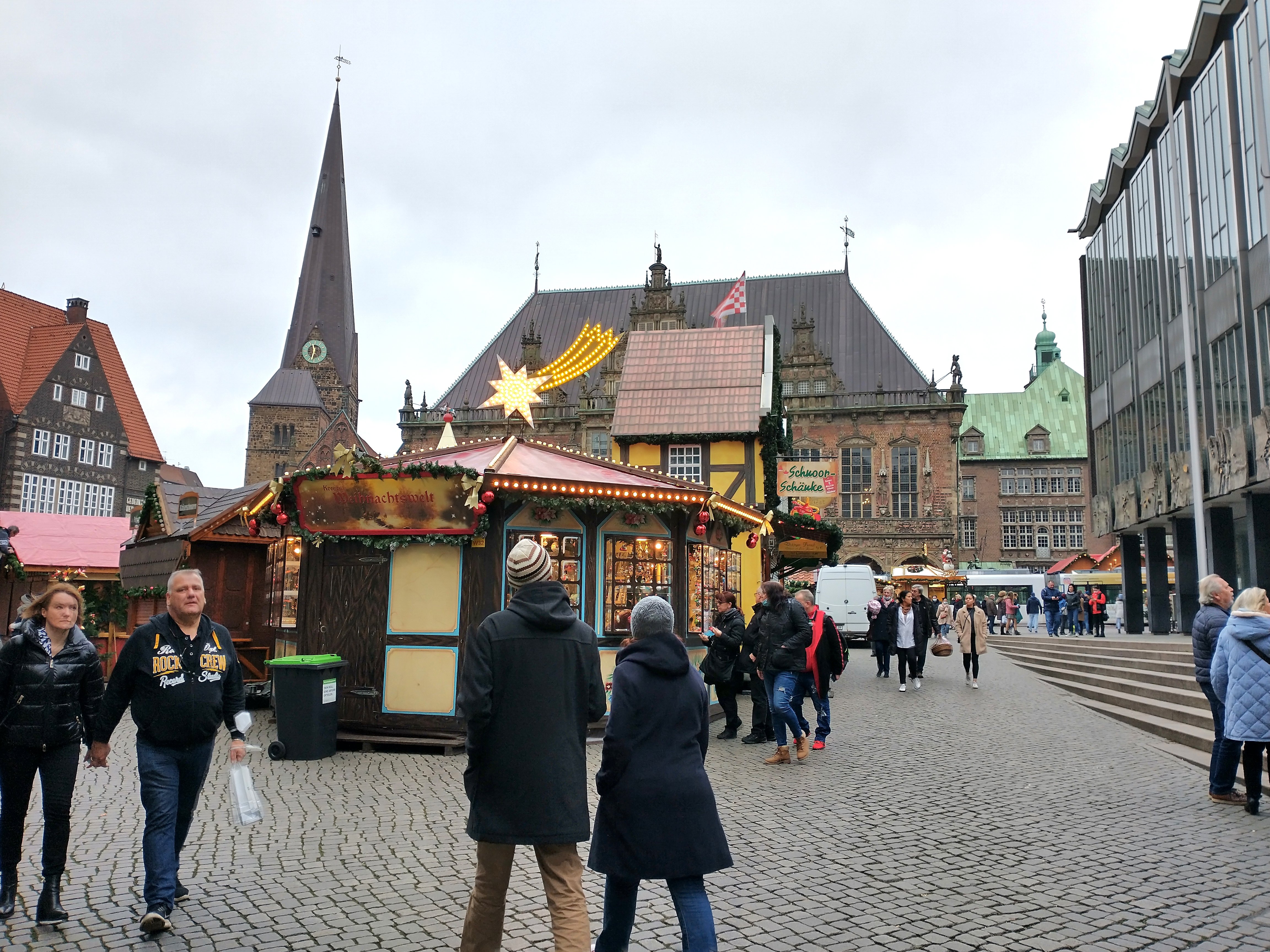 People walk through the Christmas market on the square in front of the historic Town Hall in the northern German city of Bremen before it opened Nov. 22, 2021. (CNS photo/Anli Serfontein)