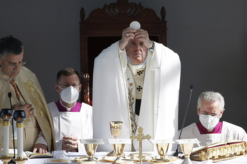 Pope Francis elevates the Eucharist as he celebrates Mass at the GSP Stadium in Nicosia, Cyprus, Dec. 3, 2021. (CNS/Paul Haring)