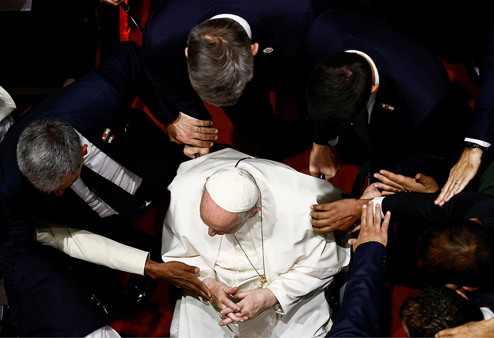 People reach out for Pope Francis during an ecumenical prayer service for peace Nov. 4, at Our Lady of Arabia Cathedral in Awali, Bahrain. (CNS/Reuters/Yara Nardi)