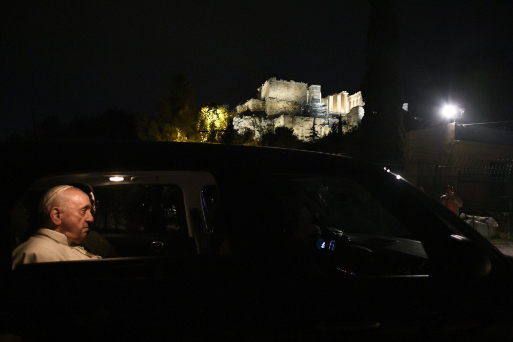 Pope Francis makes a brief stop to admire the Acropolis, the site of the Parthenon, in Athens, Greece, in this Dec. 4, 2021, file photo. The pope will give the three marble fragments from the Parthenon that have been housed in the Vatican Museums to Archbishop Ieronymos II of Athens and all Greece. (CNS photo/Vatican Media)