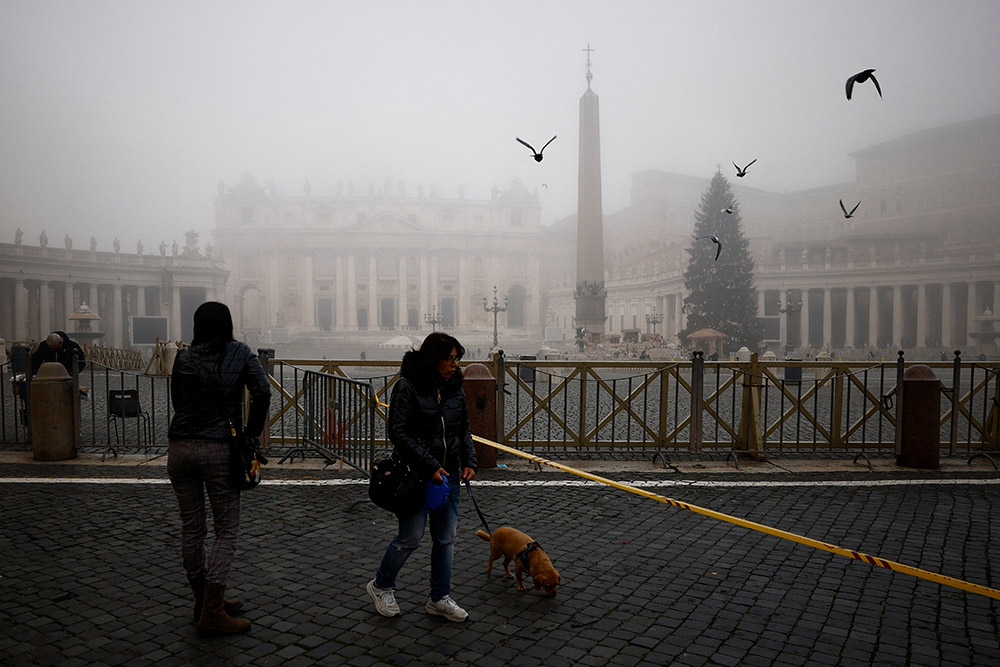 People walk near St. Peter's Square on a foggy day ahead of Pope Francis' celebration of Mass marking the feast of Mary, Mother of God, at the Vatican Jan. 1, 2022. (CNS/Reuters/Guglielmo Mangiapane)