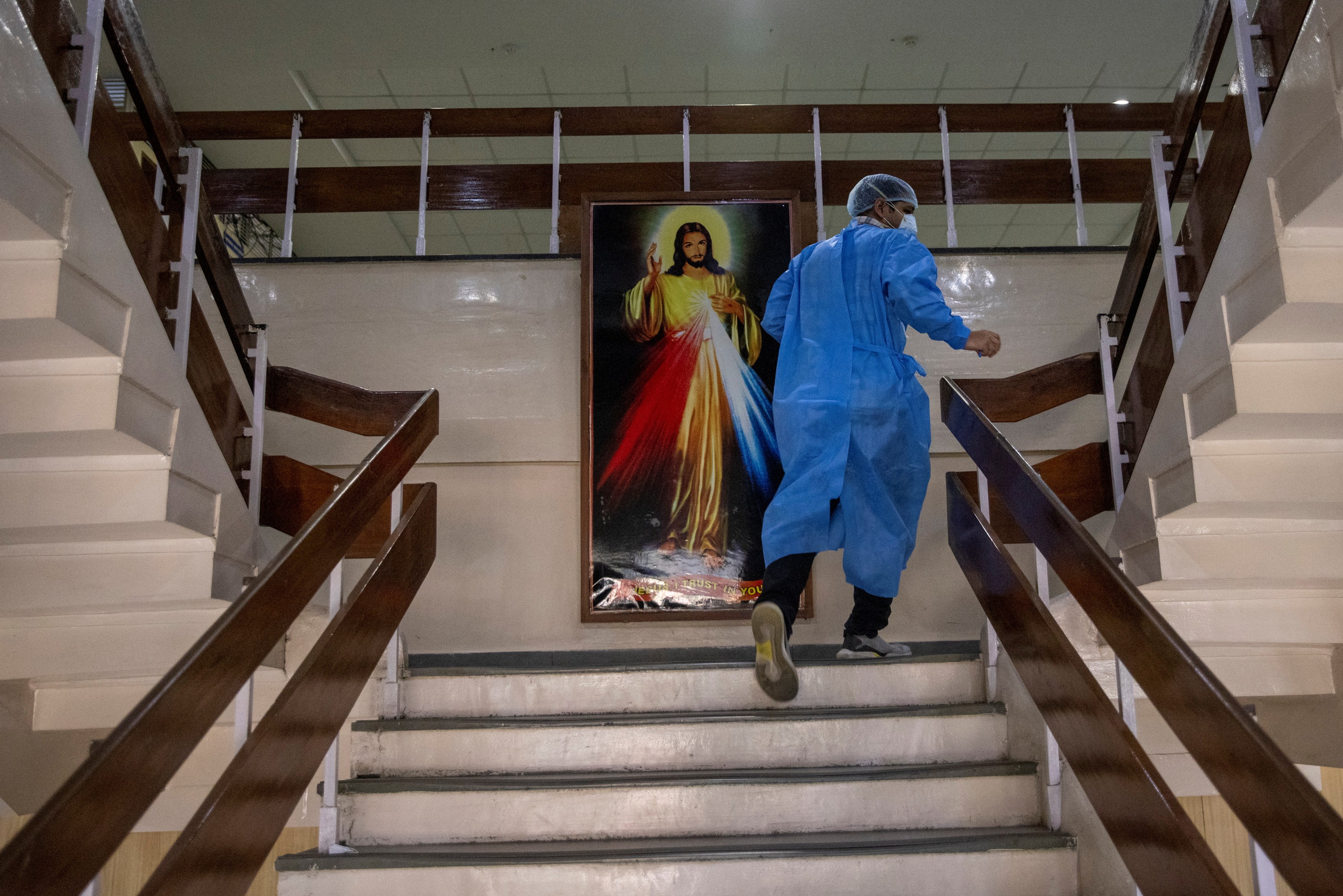 Rohan Aggarwal, 26, a resident doctor treating patients suffering from COVID-19, rushes to an emergency call at a ward for COVID-19 patients, during his 27-hour shift at Holy Family Hospital in New Delhi in this May 1, 2021, file photo. (CNS photo/Danish 