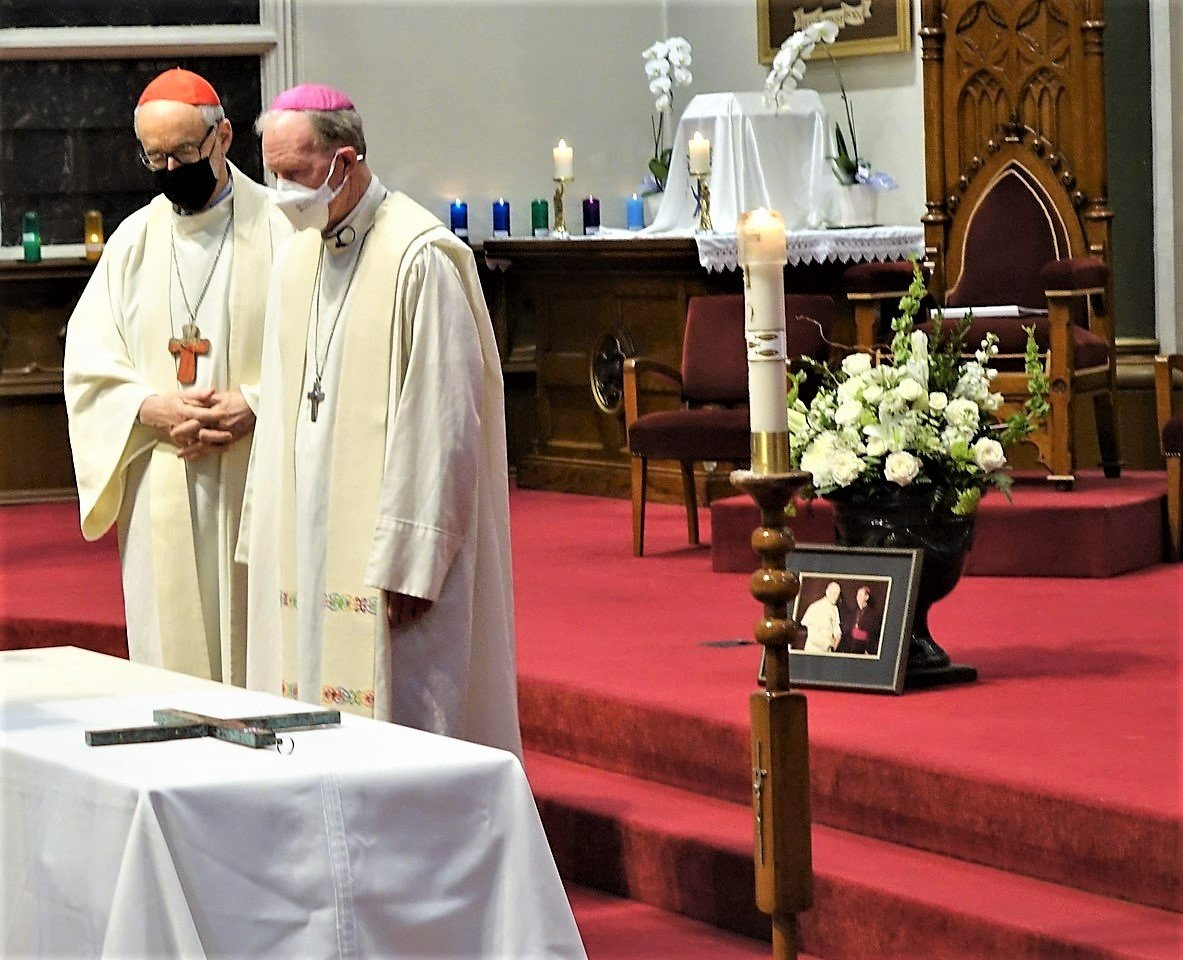 Canadian Cardinal Michael Czerny and Bishop Gary Gordon of Victoria, British Columbia, stand near the coffin of retired Victoria Bishop Remi De Roo during his funeral Mass at St. Andrew's Cathedral in Victoria Feb. 12, 2022. (CNS photo/Kevin Doyle, for Ca