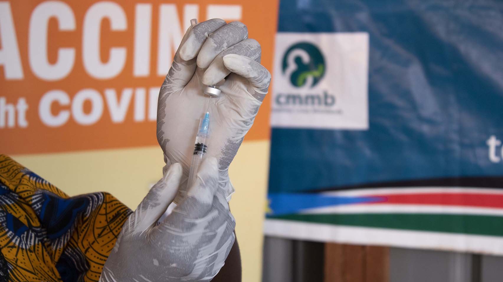 In this undated photo, a staff member with the Catholic Medical Mission Board prepares to administer a COVID-19 vaccination. (CNS photo/courtesy CMMB)