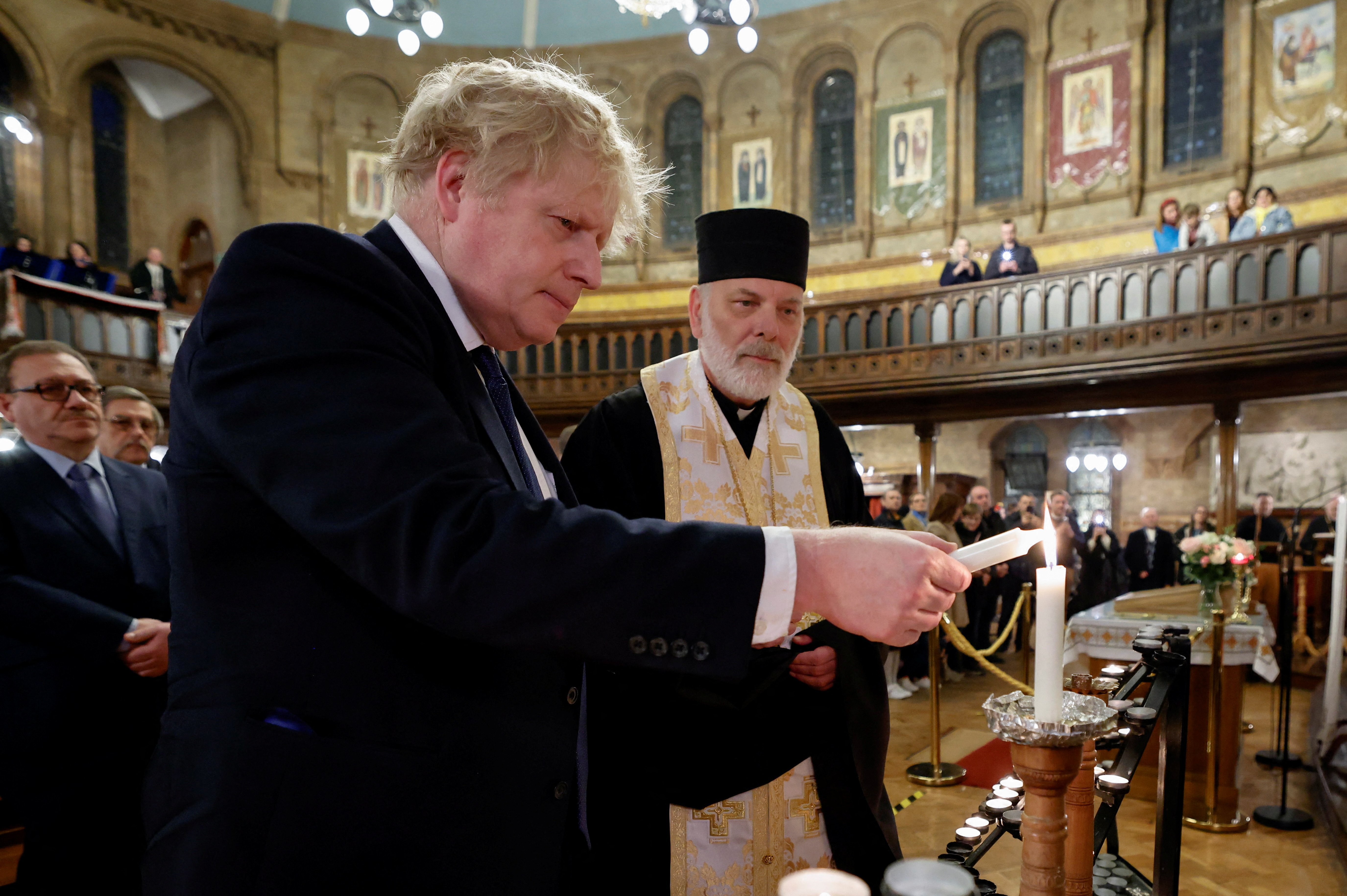 British Prime Minister Boris Johnson attends a prayer service with Bishop Kenneth Nowakowski, head of the Ukrainian Catholic Diocese of the Holy Family in London, at the Ukrainian Catholic cathedral in London Feb. 27, 2022. (CNS photo/Jamie Lorriman, Pool