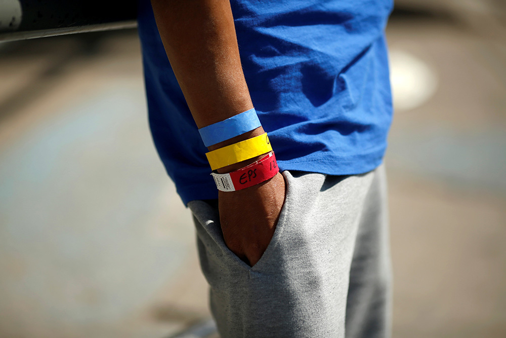 Bracelets used by the U.S. Border Patrol are seen on the arm of a Central American migrant near the Paso del Norte international border bridge in Ciudad Juarez, Mexico, Oct. 1, 2021.