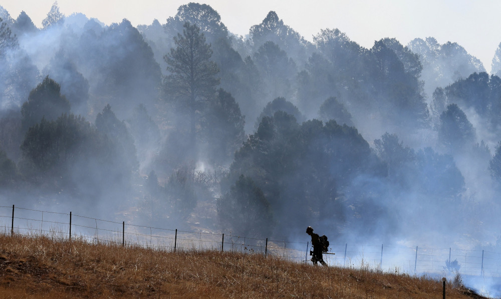 A firefighter near Las Vegas, N.M., works to combat the Hermits Peak and Calf Canyon wildfire May 4, 2022. (CNS/Reuters/Kevin Mohatt)