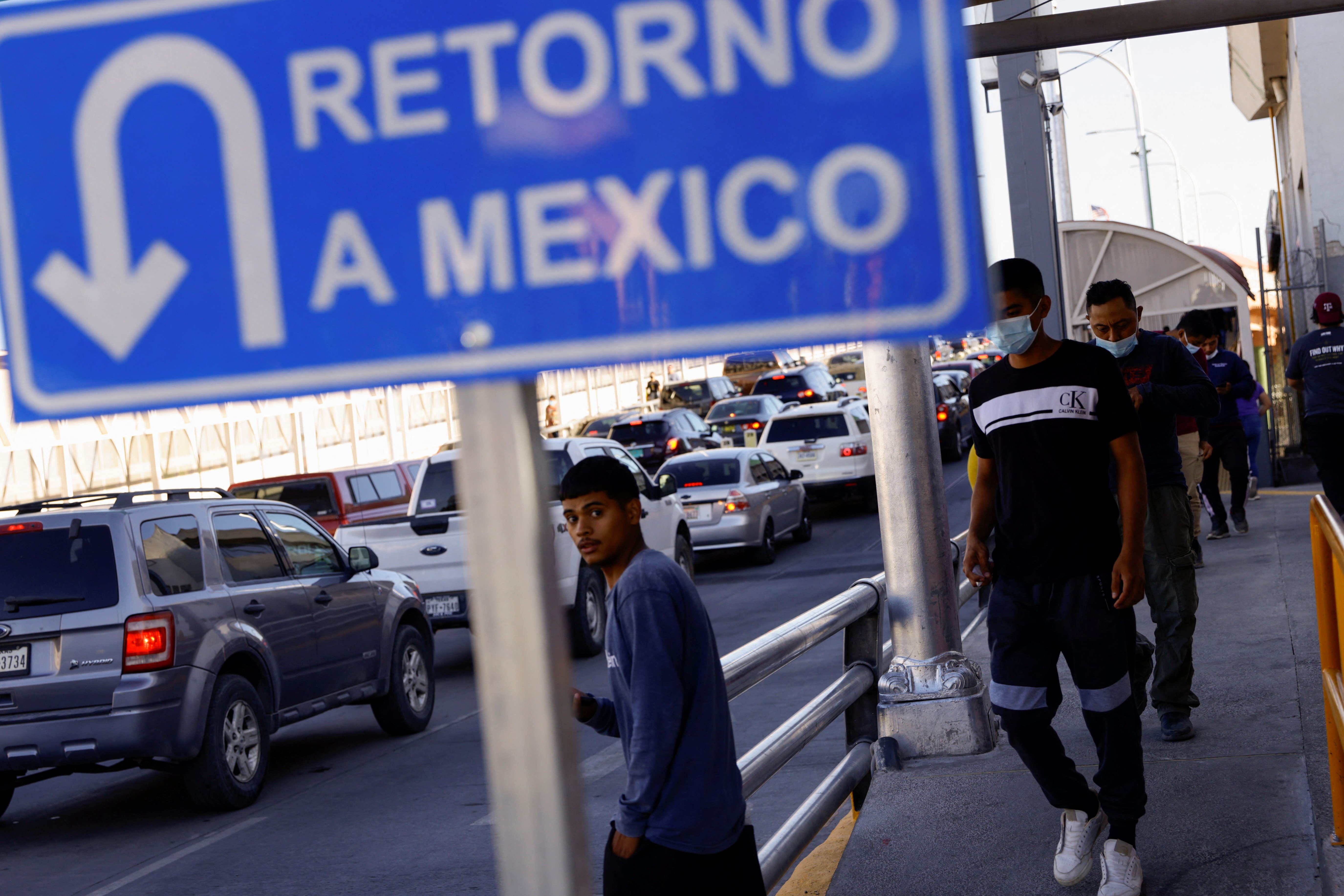 Migrants expelled from the U.S. and sent back to Mexico under Title 42 walk toward Mexico at the Paso del Norte International border bridge in Ciudad Juarez, Mexico, May 21, 2022. (CNS photo/Jose Luis Gonzalez, Reuters)