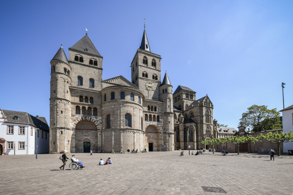 People walk outside the Cathedral of St. Peter and the Church of Our Lady in Trier, Germany, May 15, 2020.