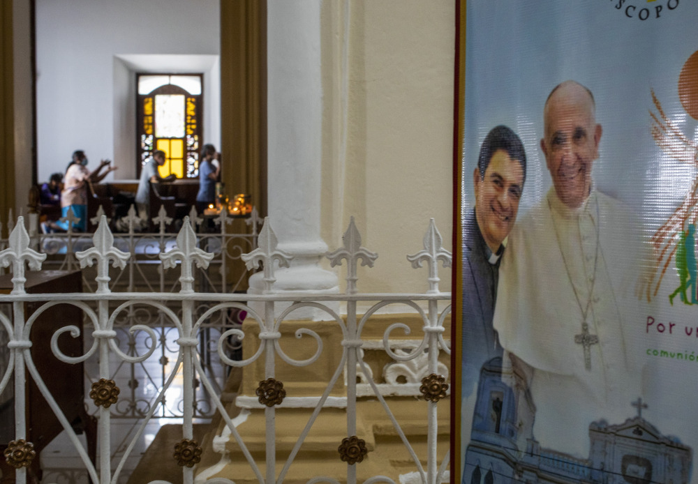 A poster of Pope Francis and Bishop Rolando Alvarez stands outside a sanctuary