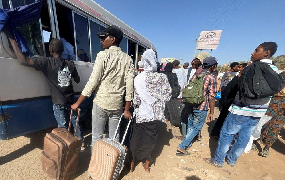  People fleeing clashes between the paramilitary Rapid Support Forces and the army gather at the bus station in Khartoum, Sudan, on April 19. (OSV News/Reuters/El-Tayeb Siddig)