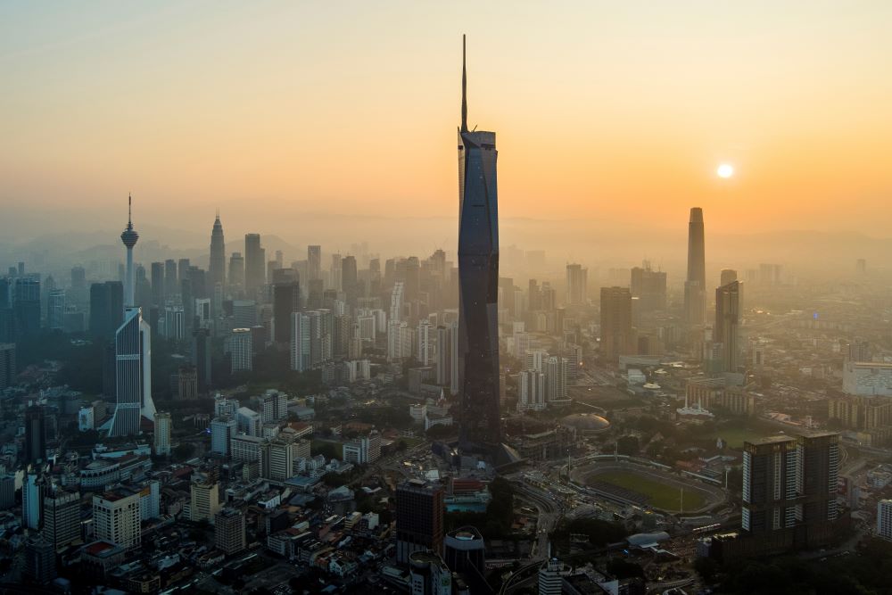 The sun rises over downtown Kuala Lumpur, Malaysia on April 11, 2023. (AP Photo/Vincent Thian)