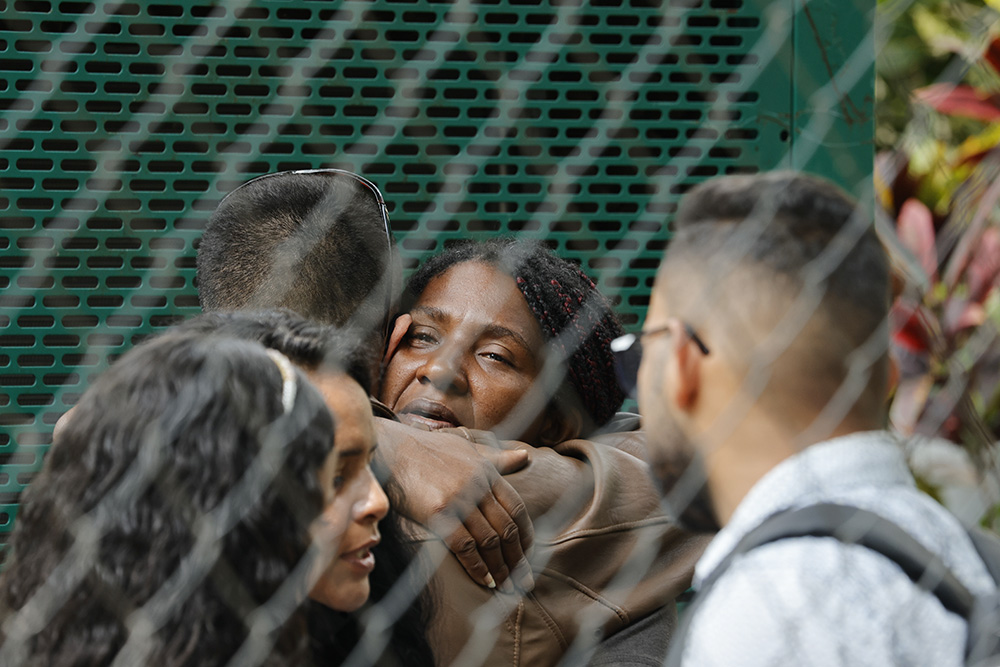 Angie Milagros Infante, mother of Rannier Requena Infante, who died at a migrant facility fire March 27 in Ciudad Juárez, Mexico, embraces relatives after recognizing the body of her son at a morgue in Caracas, Venezuela, April 17. (AP/Jesus Vargas)