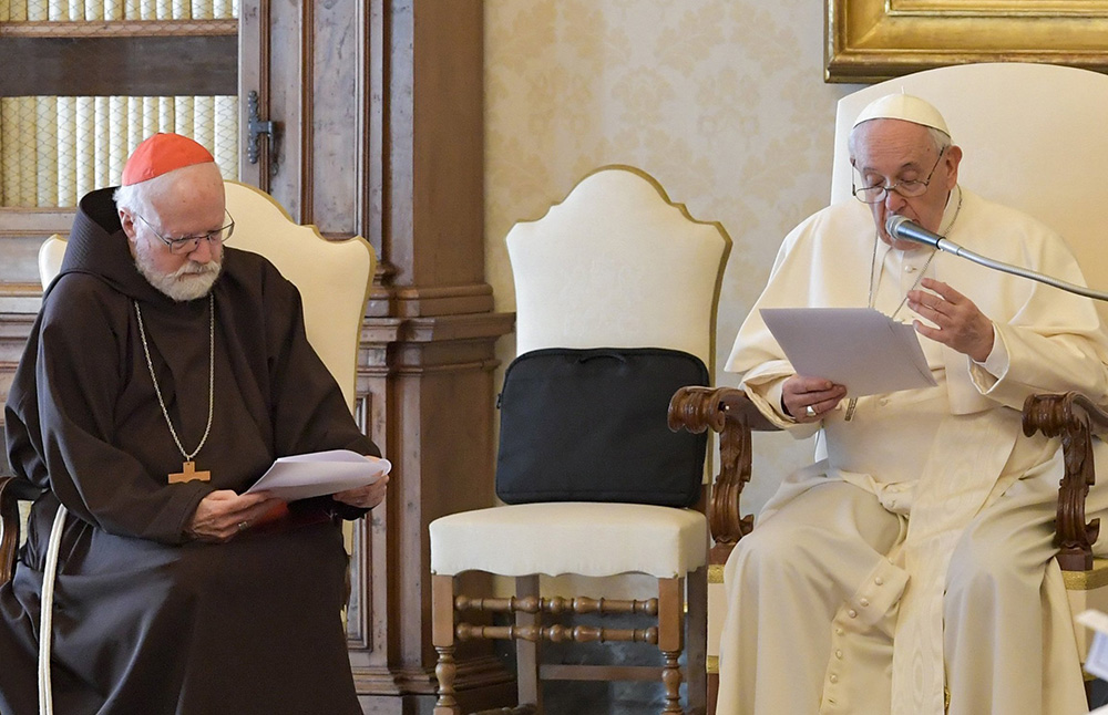 Boston Cardinal Sean O'Malley listens as Pope Francis speaks during a meeting with members of the Pontifical Commission for the Protection of Minors at the Vatican April 29, 2022. (CNS/Vatican Media)