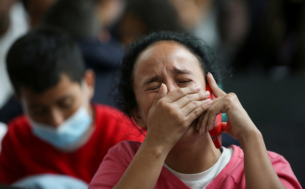 A Colombian migrant woman reacts at the El Dorado International Airport in Bogota, Colombia, May 11, 2023, after being deported from the United States, as the U.S. prepares to lift the COVID-19 era restrictions known as Title 42.