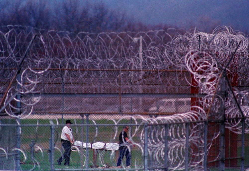 In this April 13, 1993, file photo, the body of the seventh prisoner killed in a riot at the Southern Ohio Correctional Facility in Lucasville, Ohio, is removed.