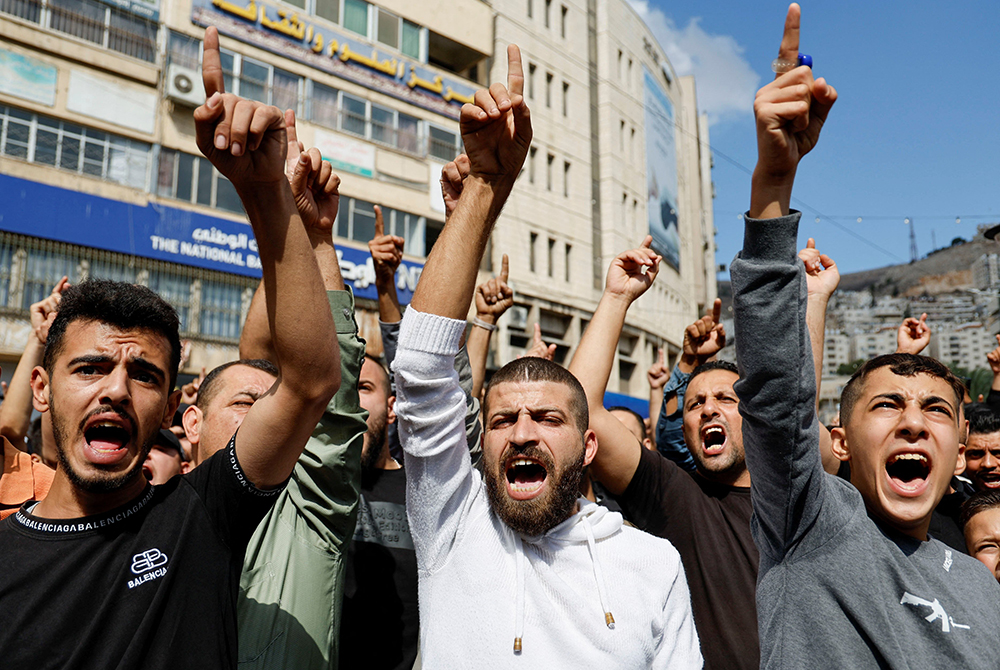 Palestinians take part in a protest in Nablus, West Bank, Oct. 18 in support of the people in Gaza, after hundreds of Palestinians were killed the previous day following an airstrike on the CNEWA-supported al-Ahli Arab Hospital in Gaza City. (OSV News/Reuters/Raneen Sawafta)