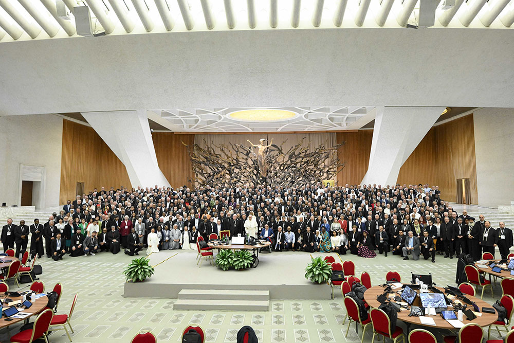 Pope Francis poses for a photo with participants in the assembly of the Synod of Bishops before a working session in the Paul VI Audience Hall at the Vatican Oct 23. (CNS/Vatican Media)