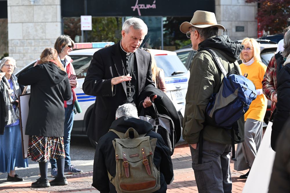 Bishop Joseph Strickland prays over an individual near the U.S. Conference of Catholic Bishops meeting in Baltimore, Nov. 15. (RNS/Jack Jenkins)