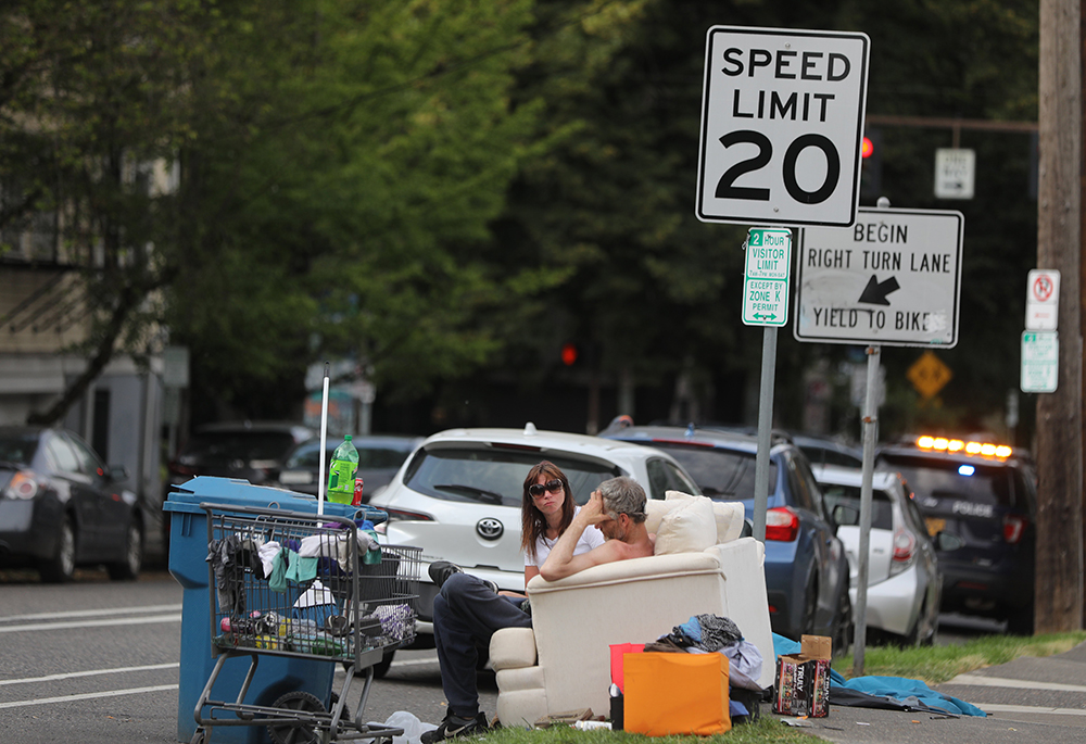 Homeless people talk outside on a couch July 5, 2022, in Portland, Oregon. (CNS/Bob Roller)