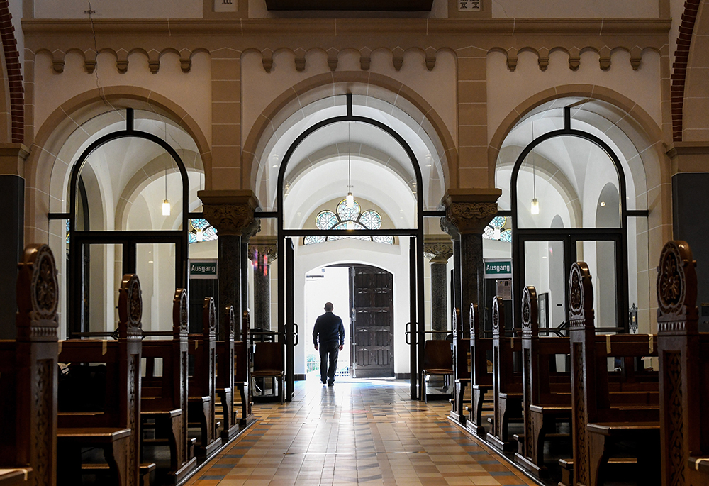 A man walks out of an empty church in Bonn, Germany in this file photo dated June 12, 2020. (OSV News/CNS/KNA/Harald Oppitz)